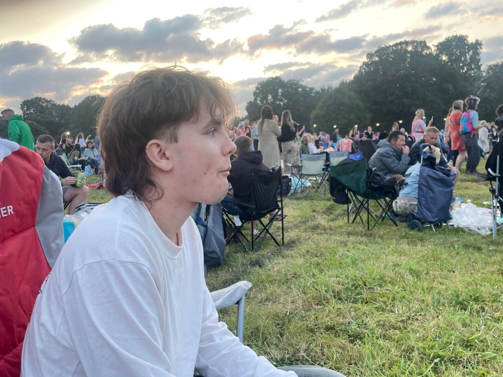 Teenaged boy eating chips at a concert