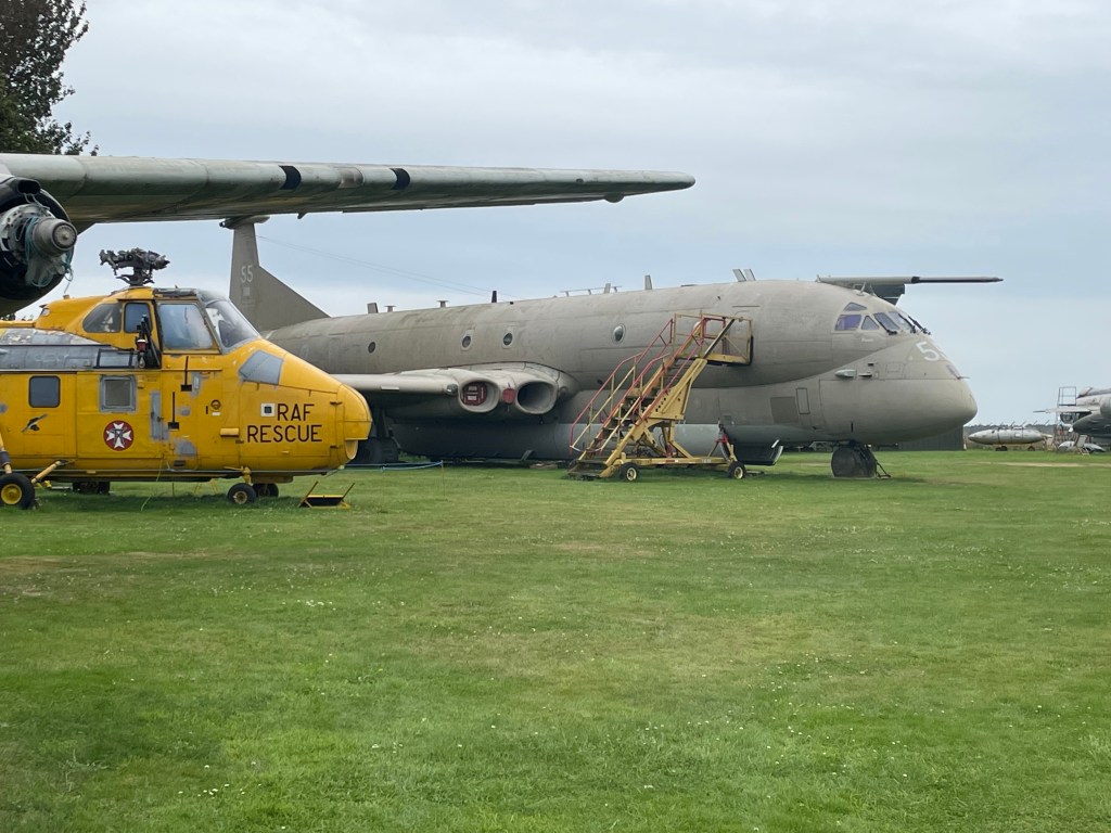 Helicopter and large airplane on display at City Of Norwich Air Museum